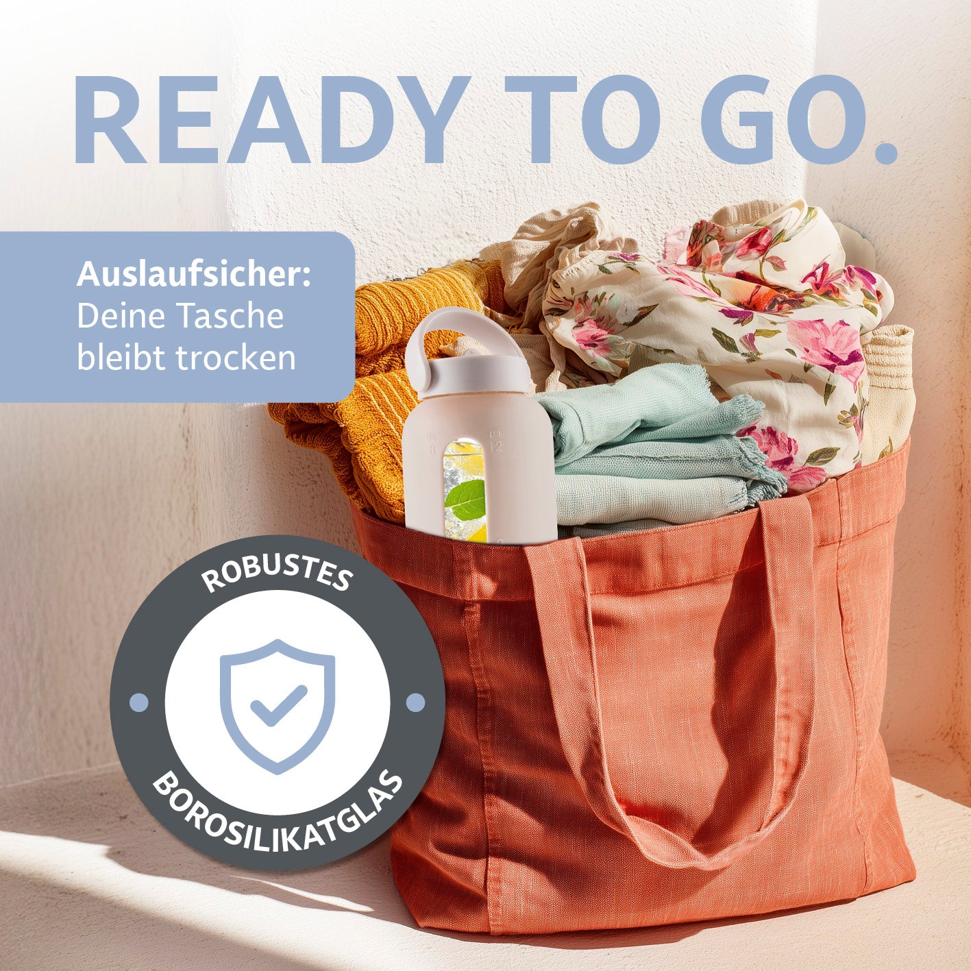 Glas-Trinkflasche – Creme aus robustem Borosilikatglas in Tasche mit Kleidung, auslaufsicher und ideal für unterwegs.