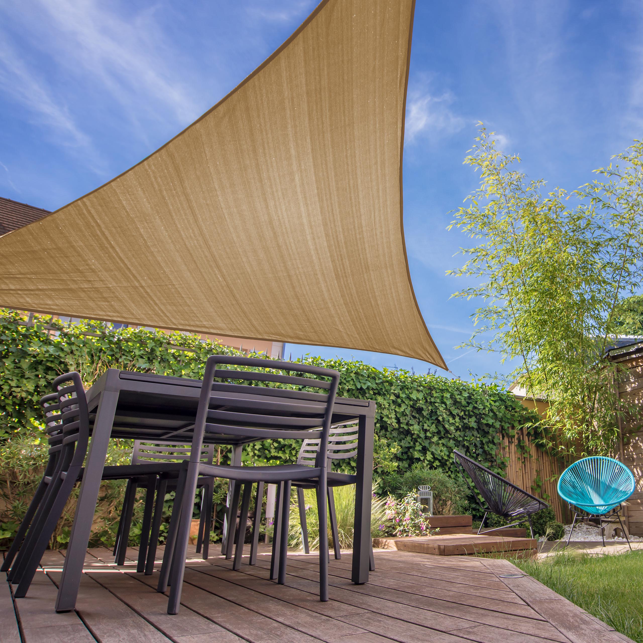 Sonnensegel 100% HDPE Dreieck 5x5x5 Meter Sandfarben mit UV-Schutz über moderner Terrasse und Gartenmöbeln.